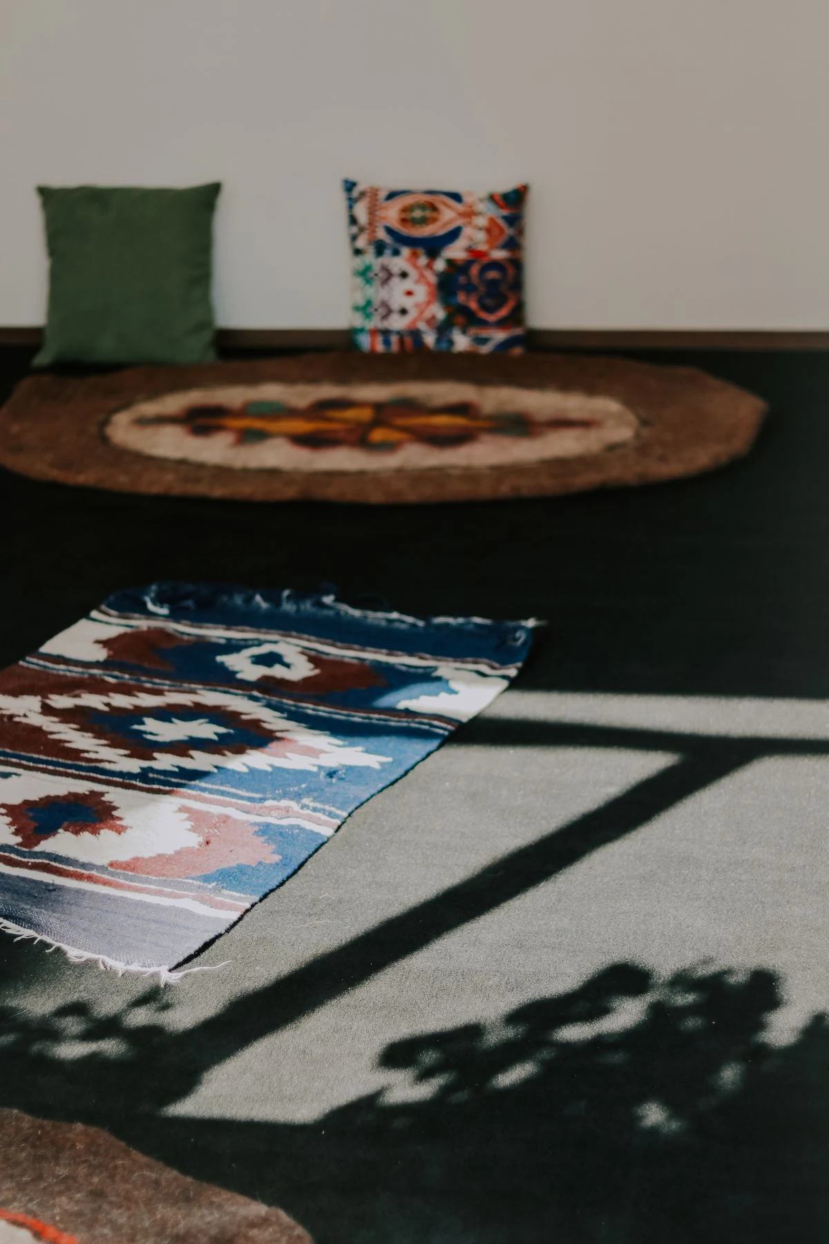 Layered rugs on the floor of a boho living room