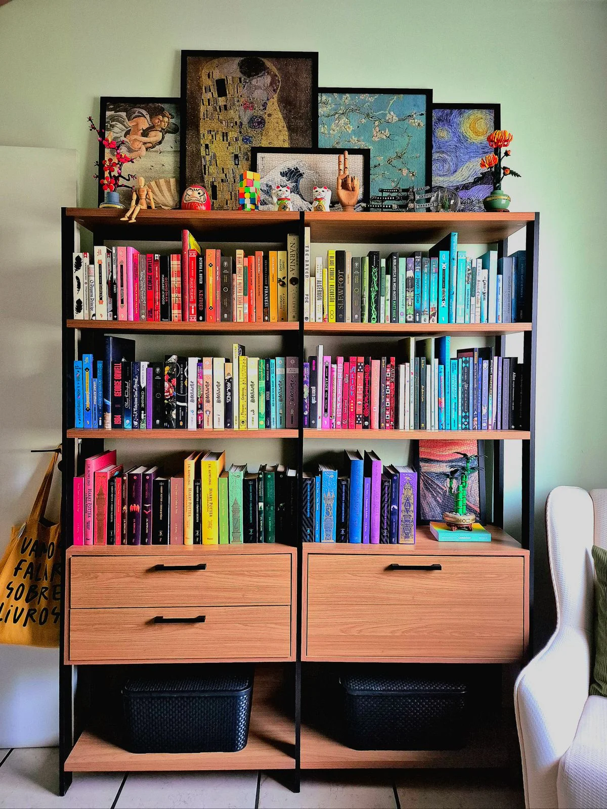Books arranged by spine color on an office bookshelf