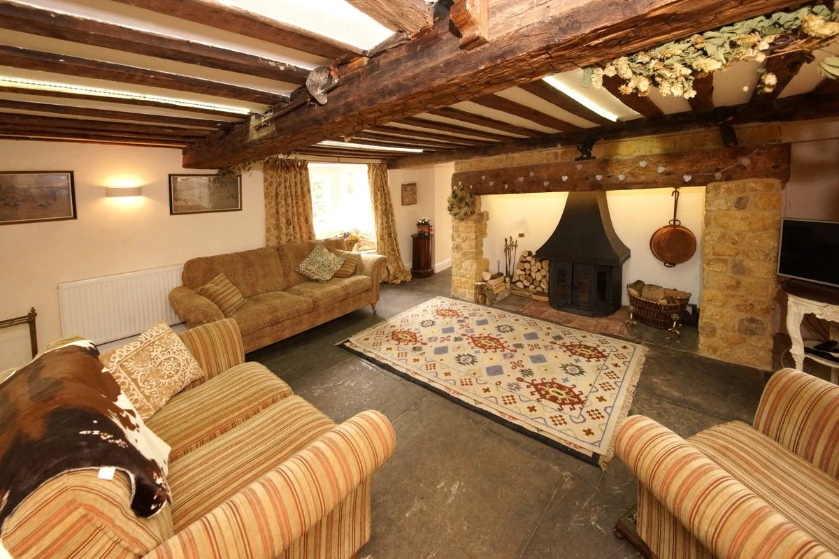 Exposed wooden ceiling beams in a farmhouse living room