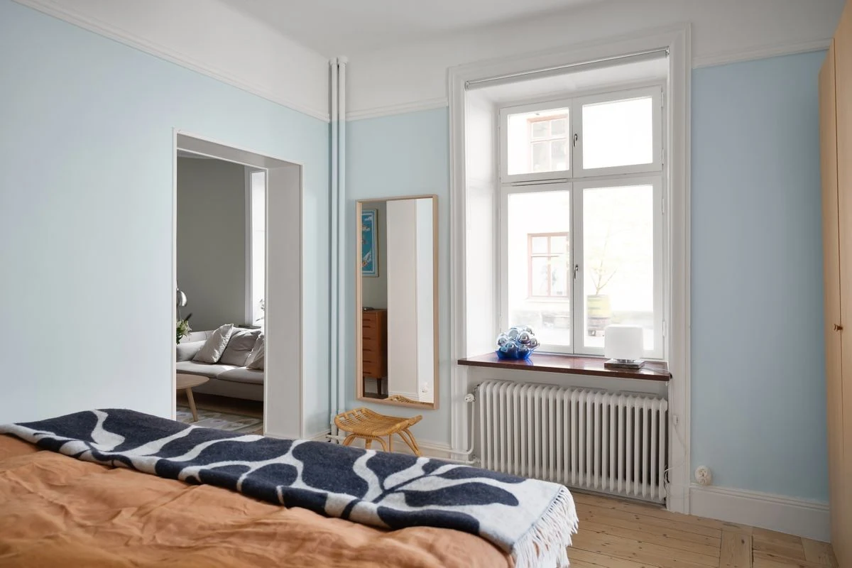 Light blue painted walls in a bright airy bedroom