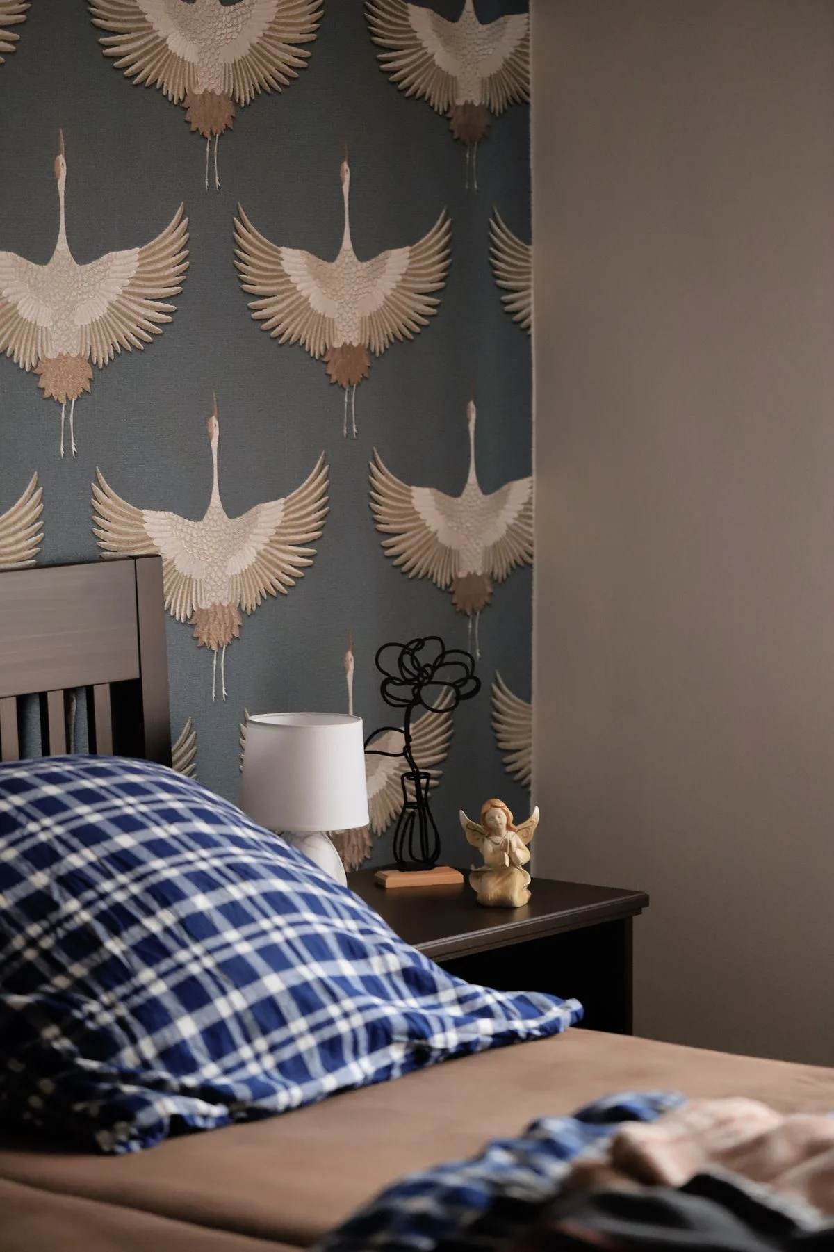 Blue patterned wallpaper on a bedroom feature wall
