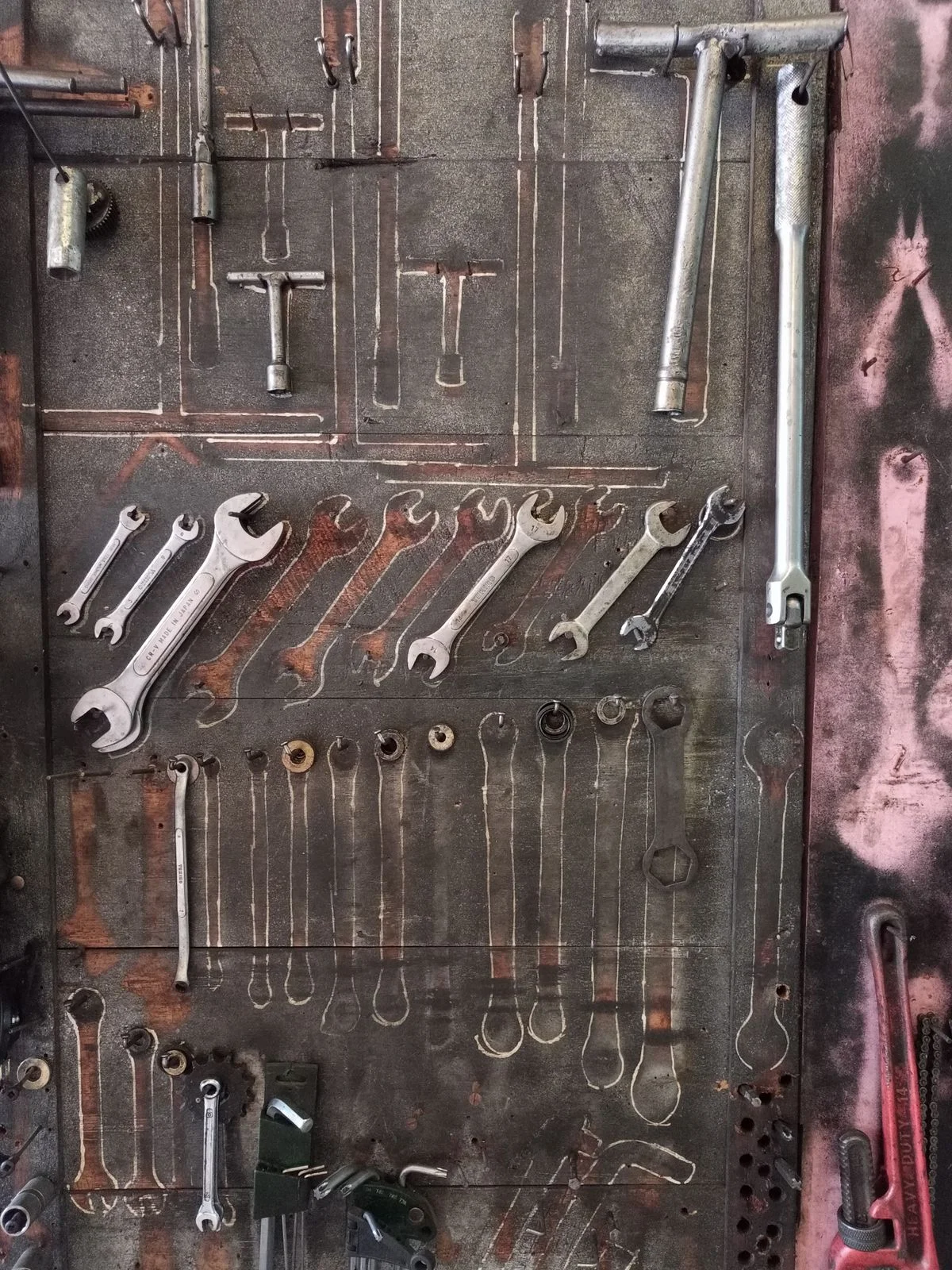 Shadow board with tool outlines on a workshop wall