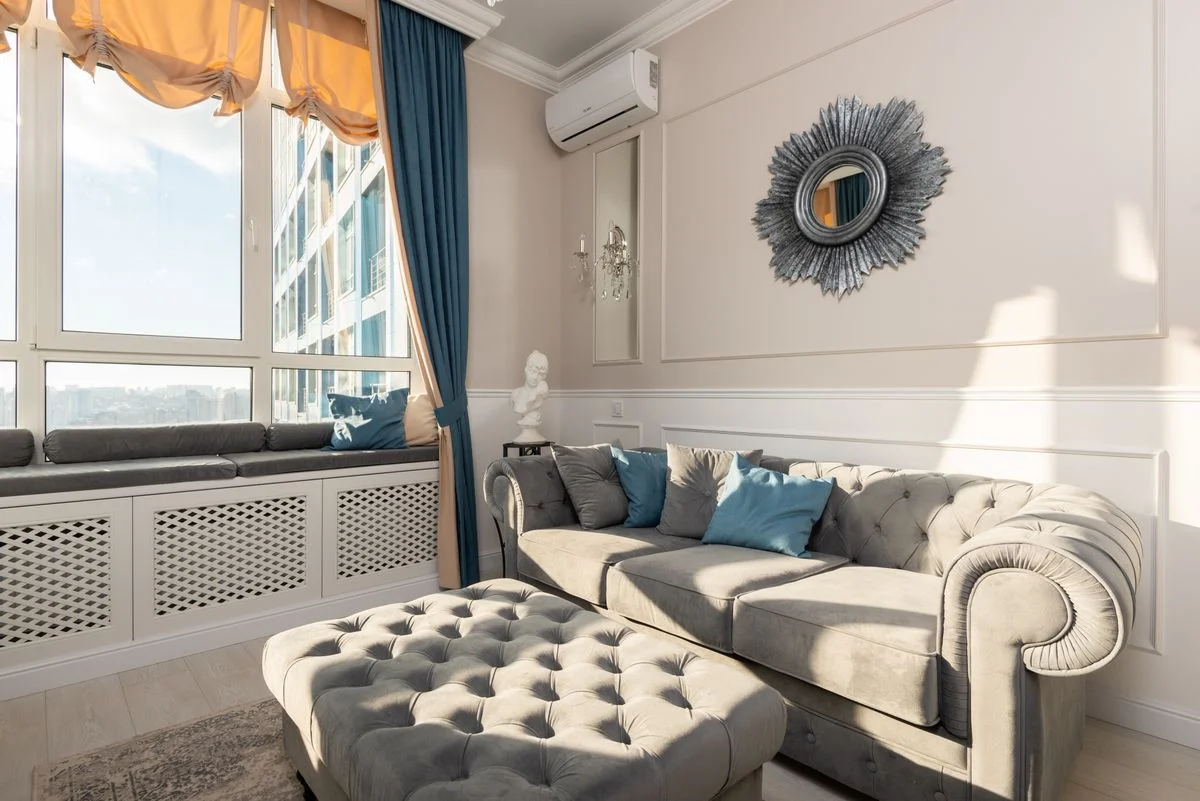 Tufted ottoman in a traditional living room