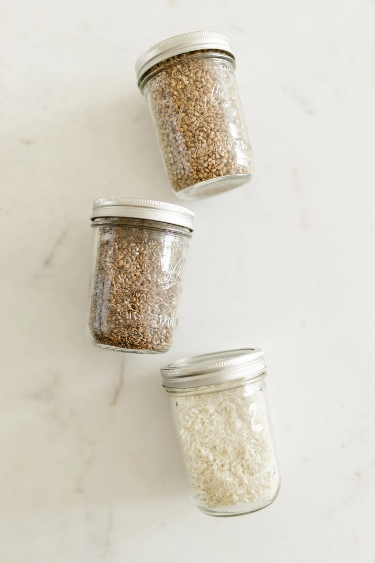 Mason jars filled with dry goods in a pantry