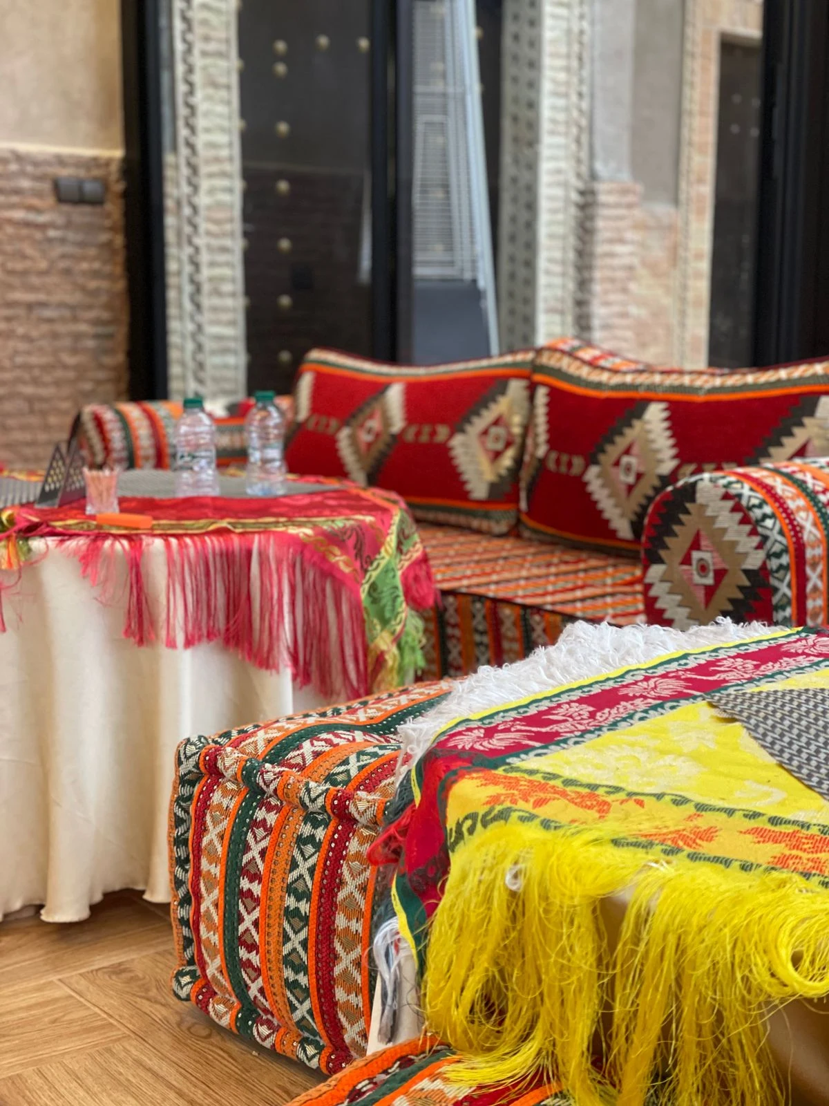 Low sofa with floor cushions in a boho living room