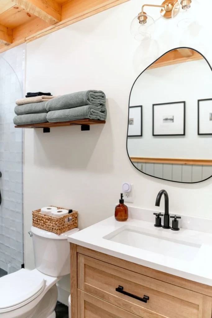 Wicker baskets with rolled towels under a bathroom vanity