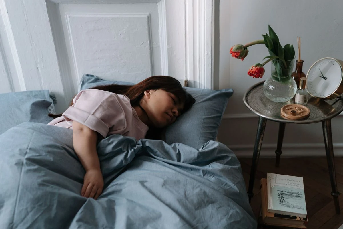Blue bedding set with layered pillows on a bed