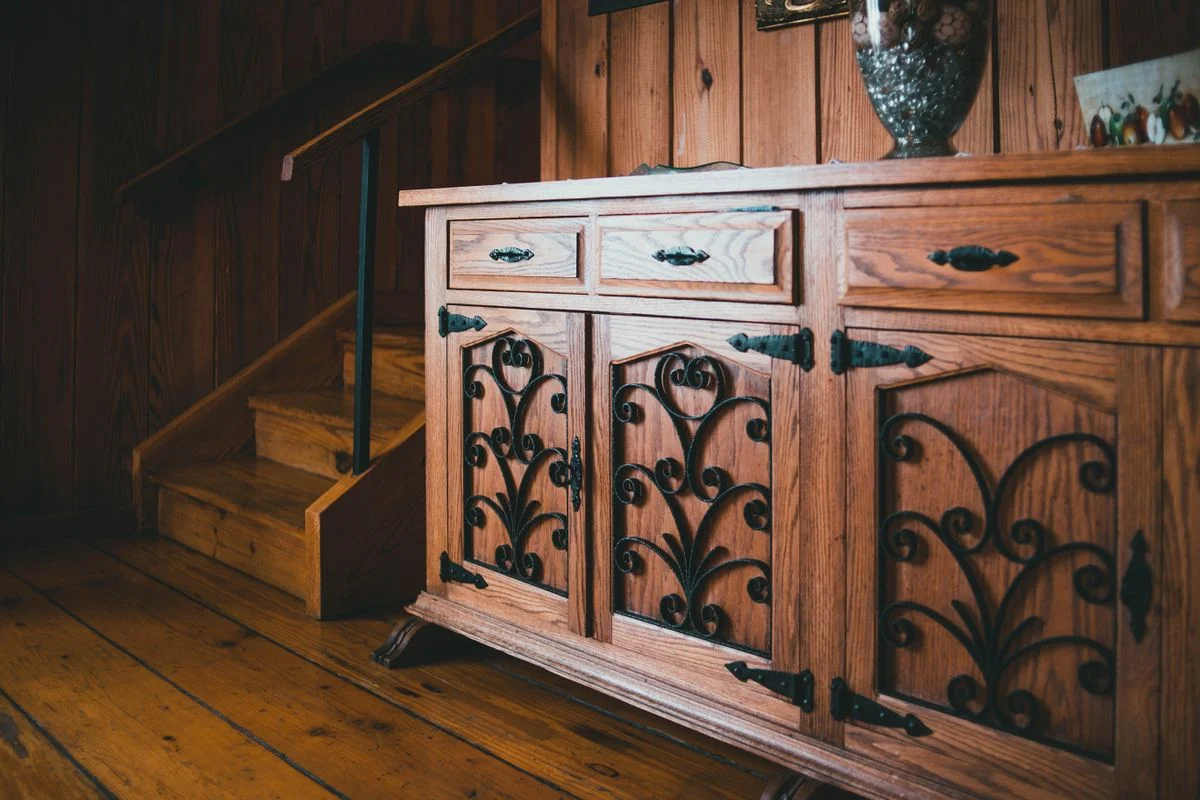 Dark wood cabinets fitted under a staircase