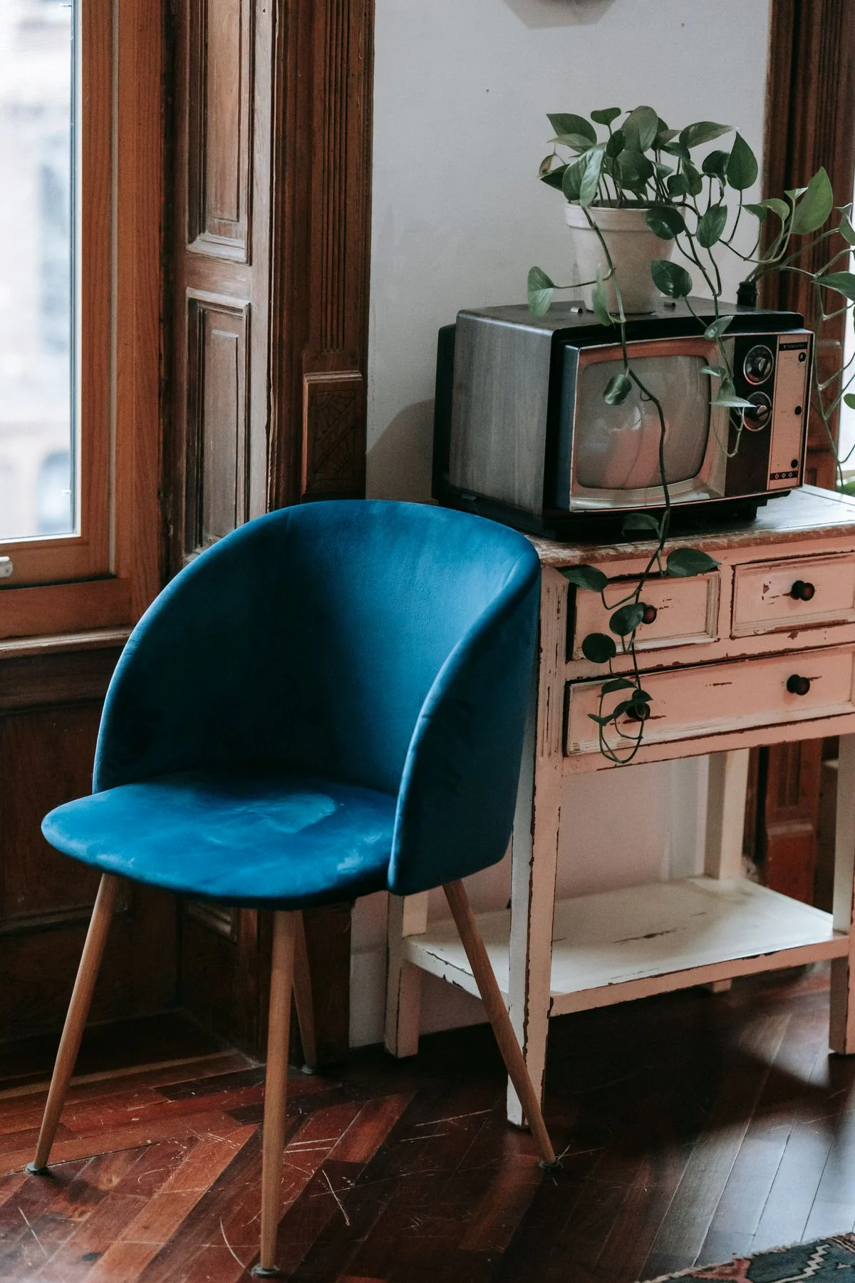 Blue velvet accent chair in a bedroom reading corner