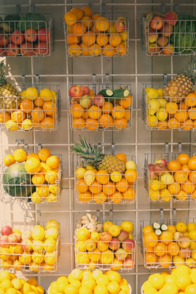 Wall-mounted wire baskets used for fruit storage in a kitchen