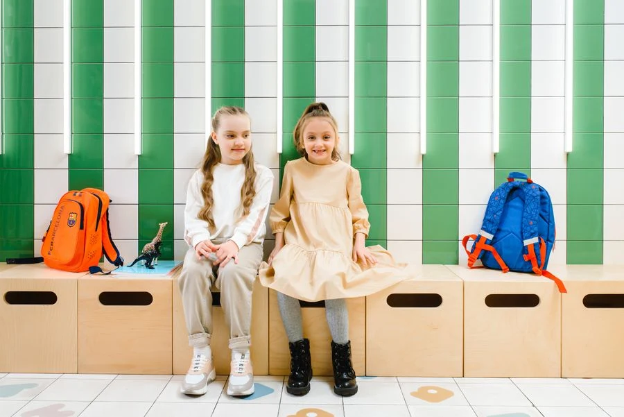 Entryway bench with cubbies underneath holding backpacks and shoes