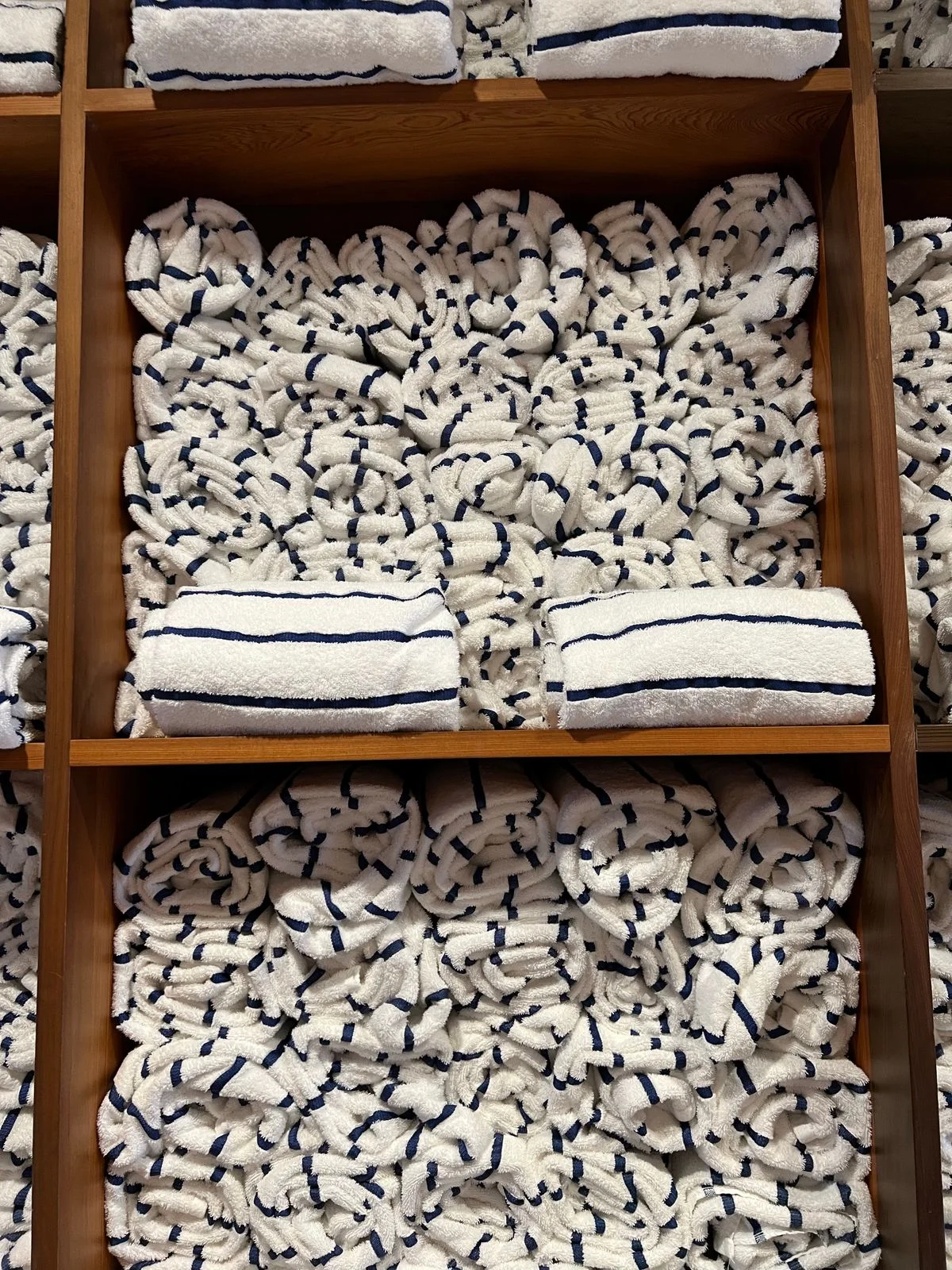 Built-in cubby shelves with folded towels in a bathroom