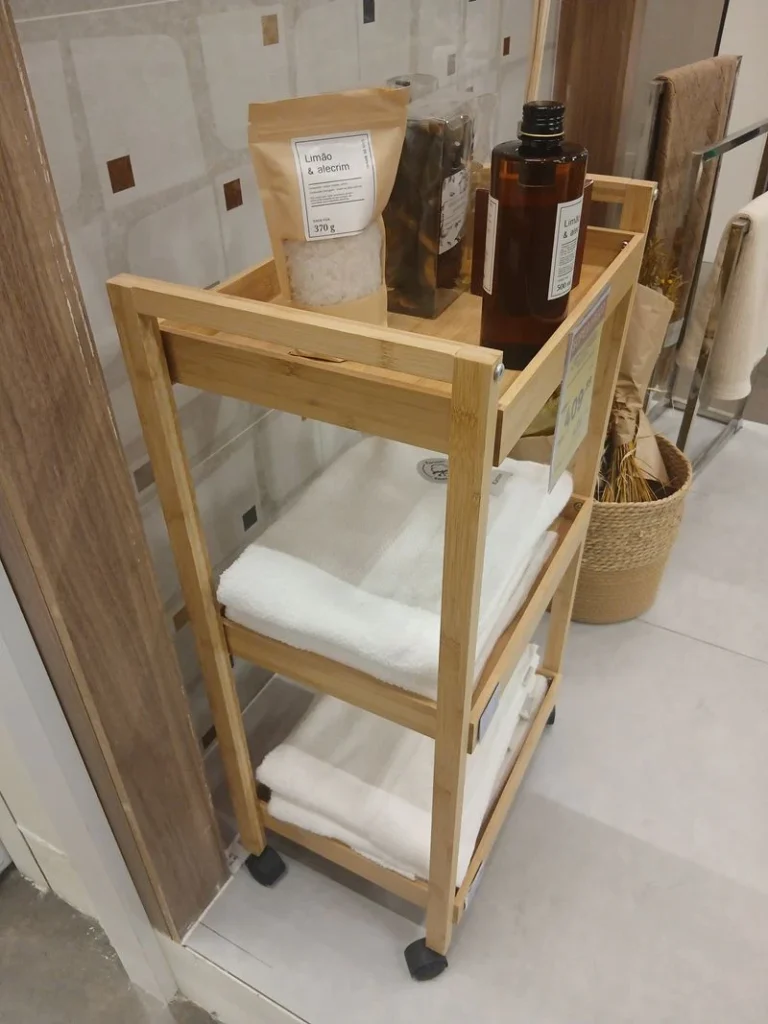 Tiered metal stand holding towels in a bathroom corner