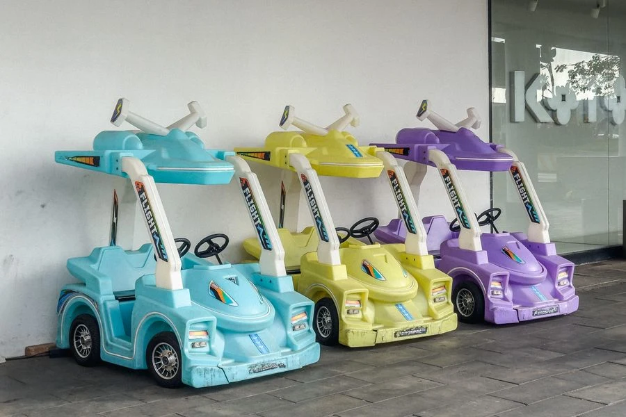 Ride-on toy cars parked in a garden parking area