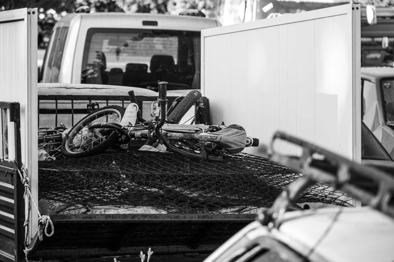 Cargo net and tie-down grid securing gear in a truck bed
