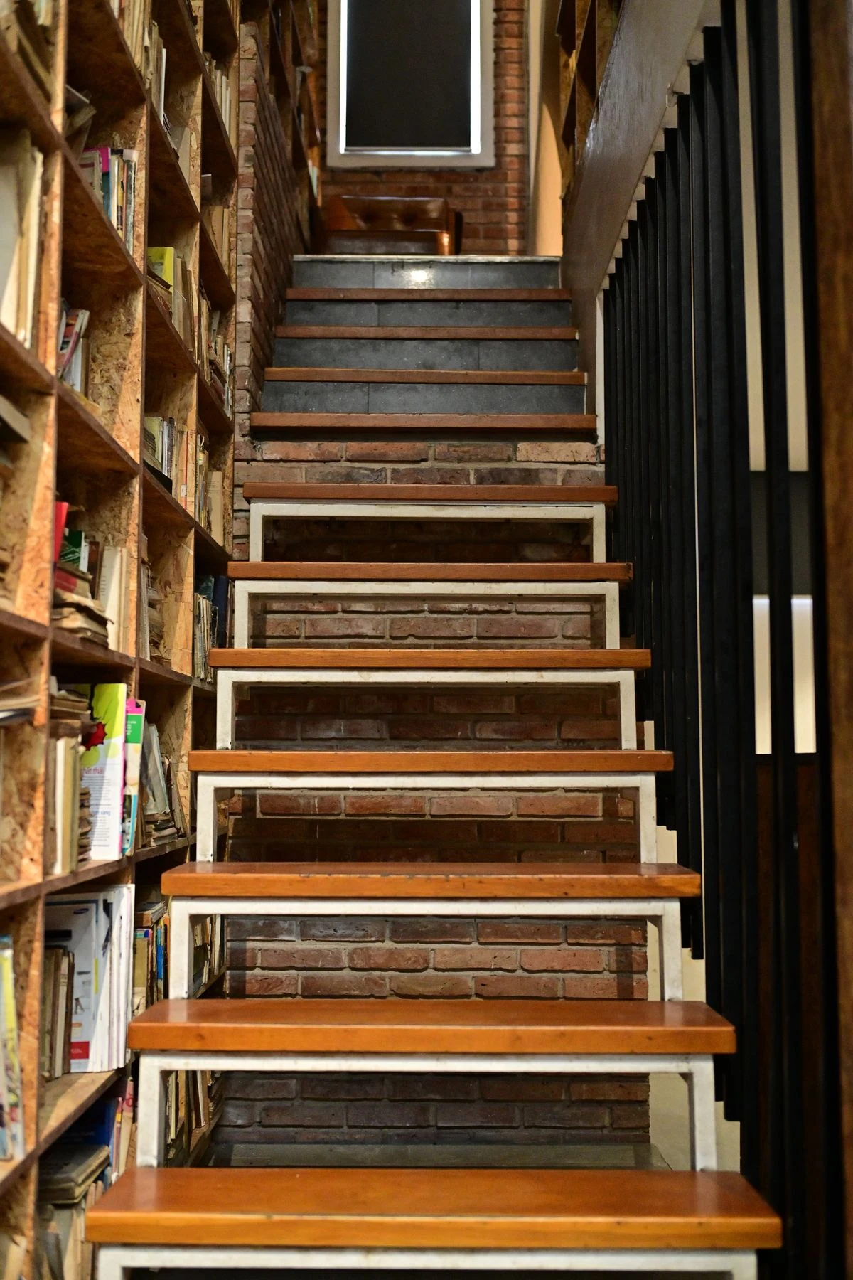 Built-in bookcase running along a staircase wall