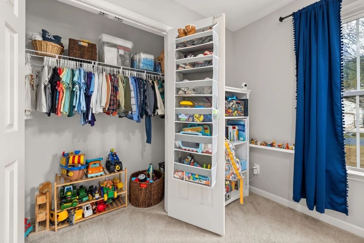 Kids closet organizer with low rods and colourful bins