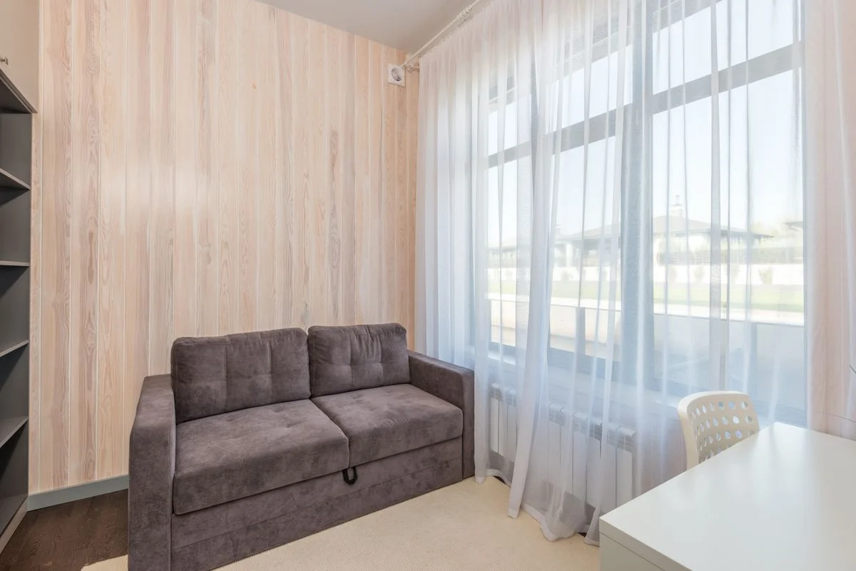Sheer curtains on windows in a small living room
