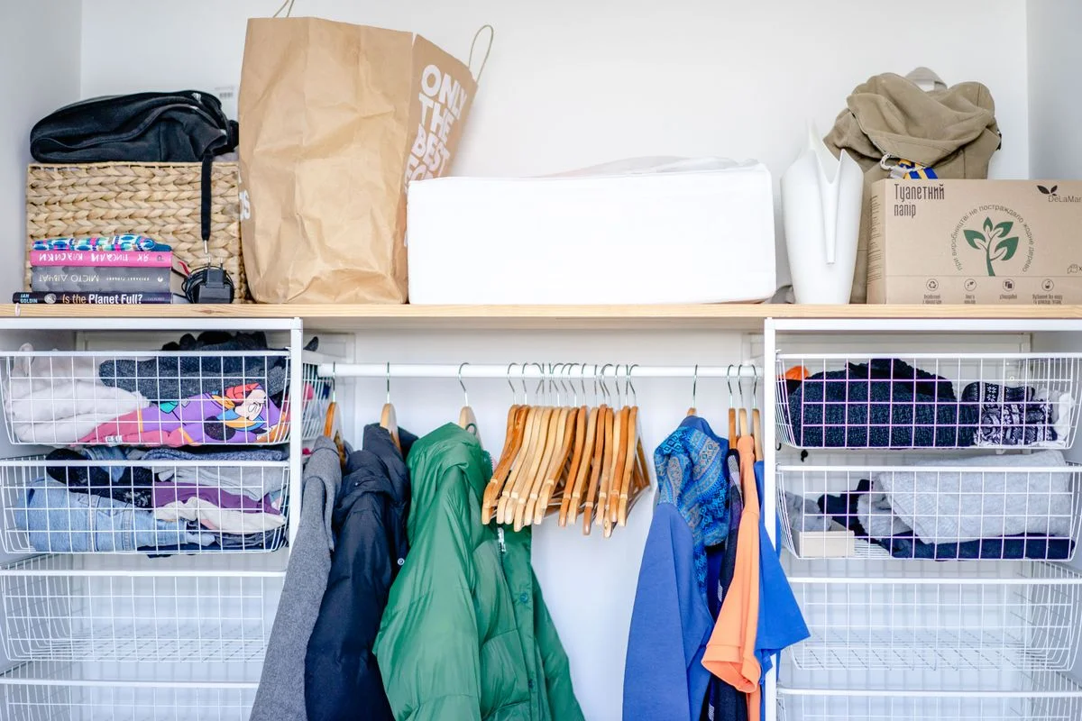 Seasonal rotation bins stored on the top shelf of a closet