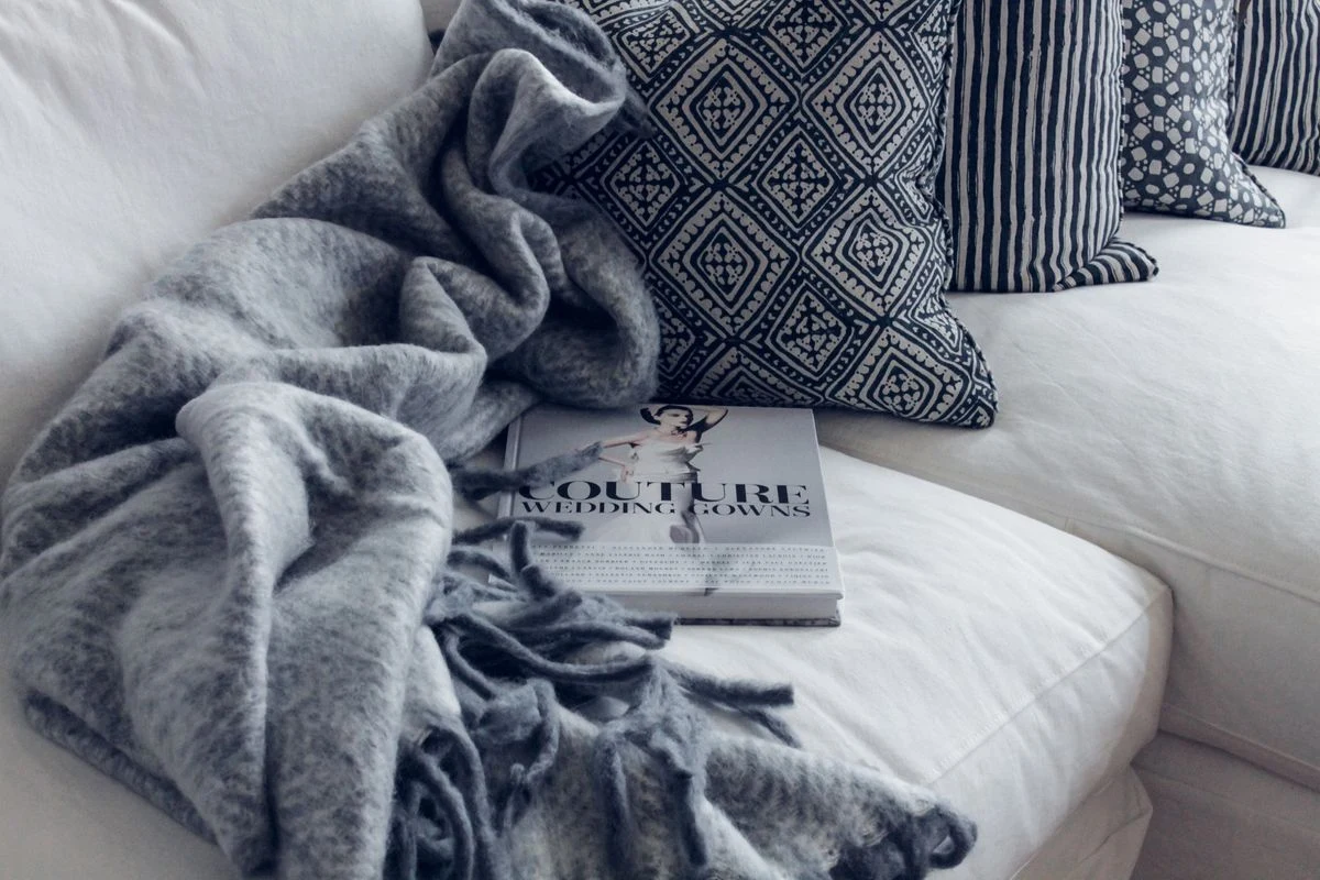 Cozy layered throws and pillows in a traditional living room