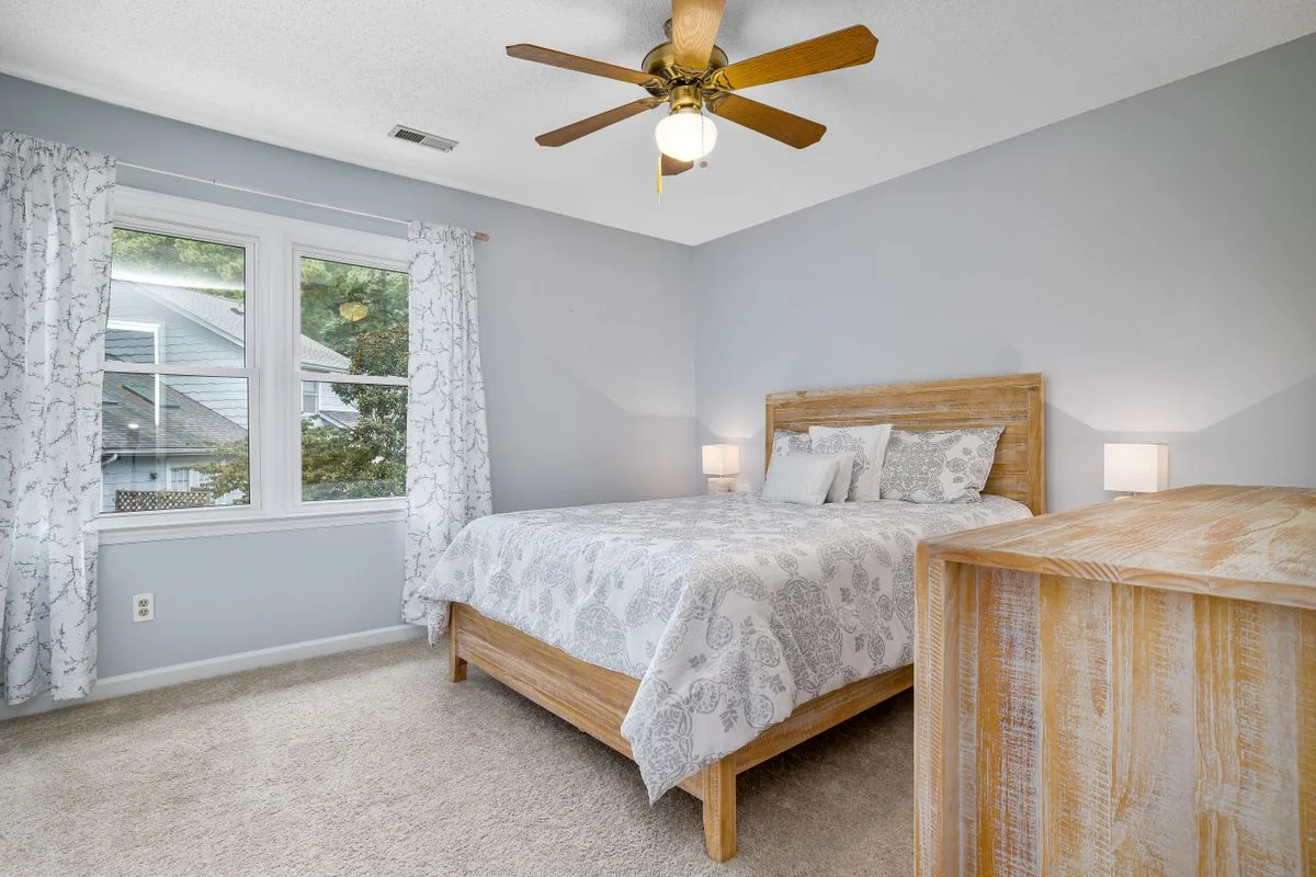 Blue bedroom with natural wood furniture and warm tones
