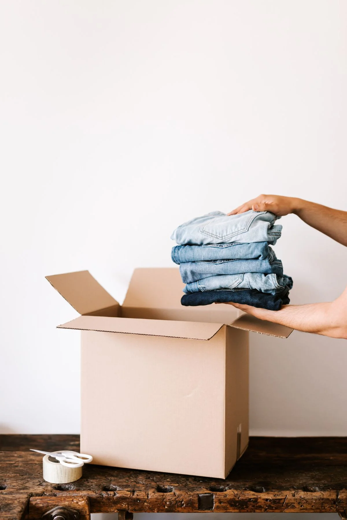 Folded clothes stored in boxes for seasonal rotation