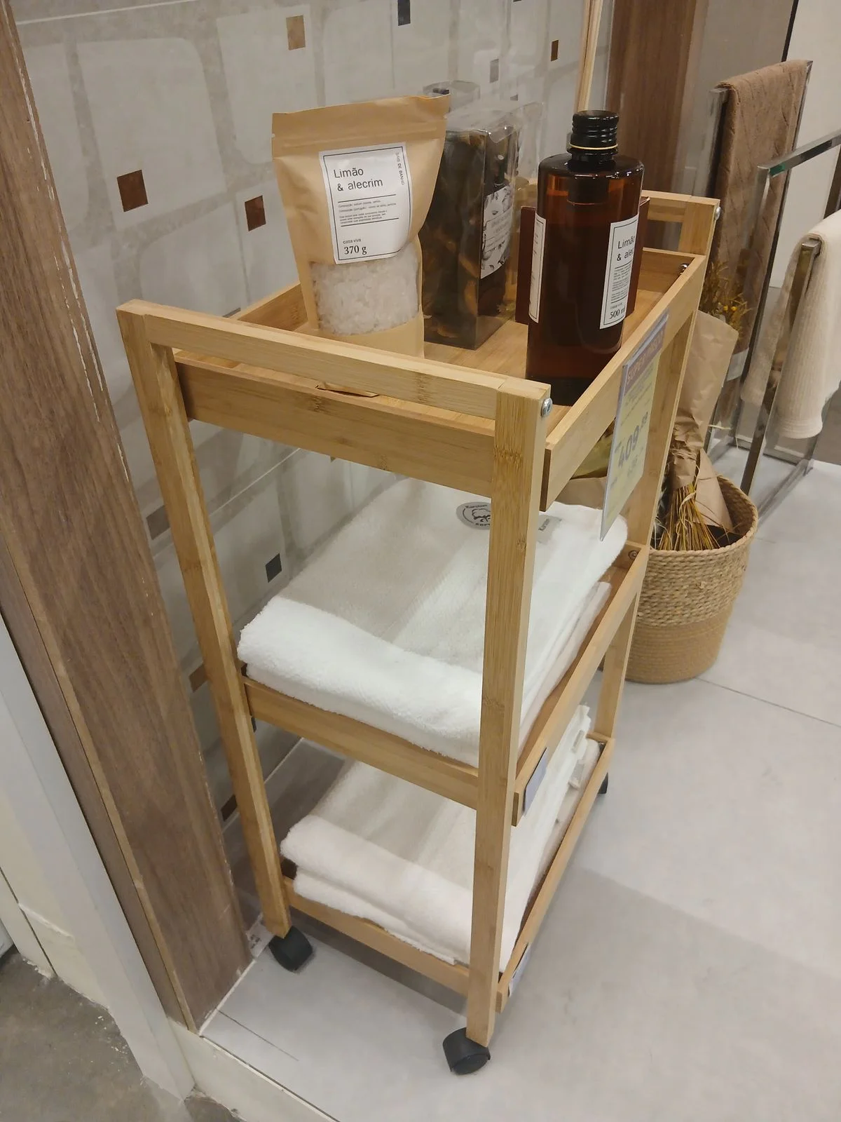 Small rolling cart with bathroom supplies beside a shower