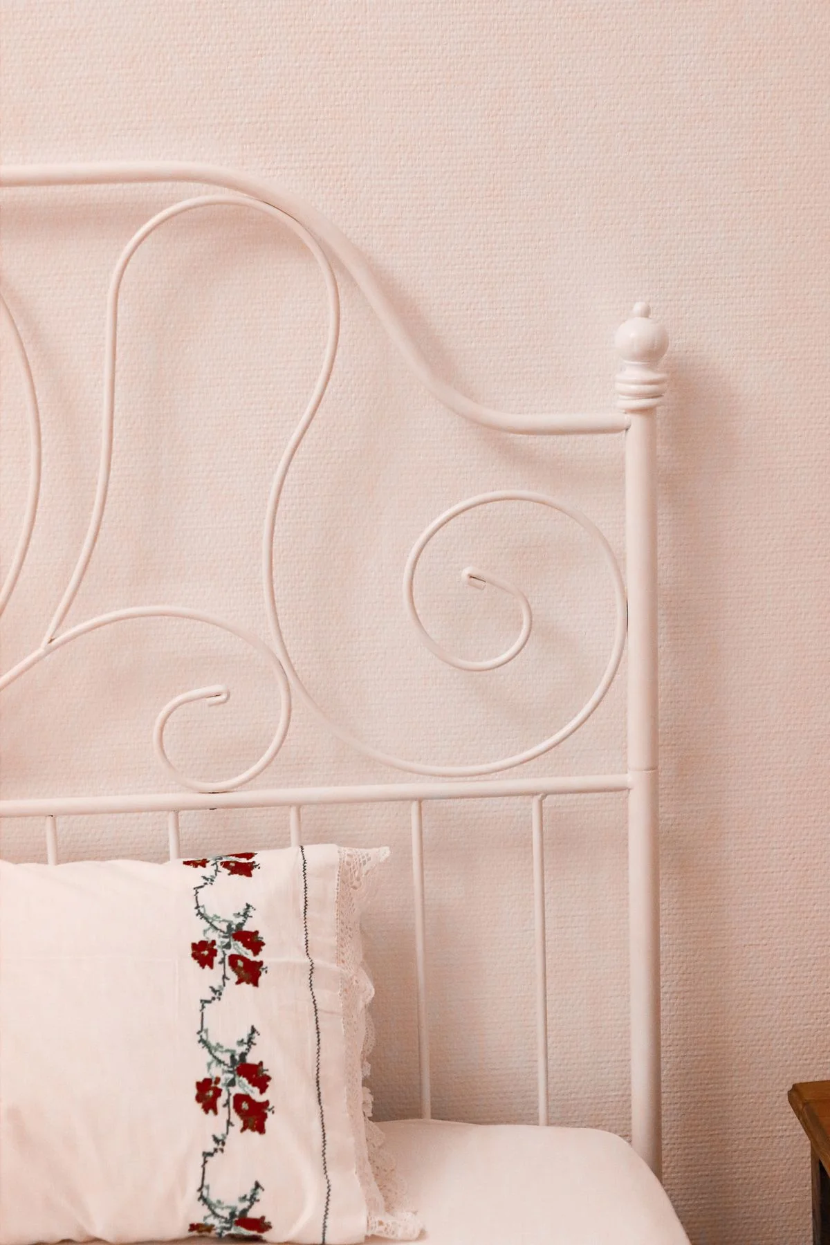 Pink and white romantic cottage bedroom with floral bedding
