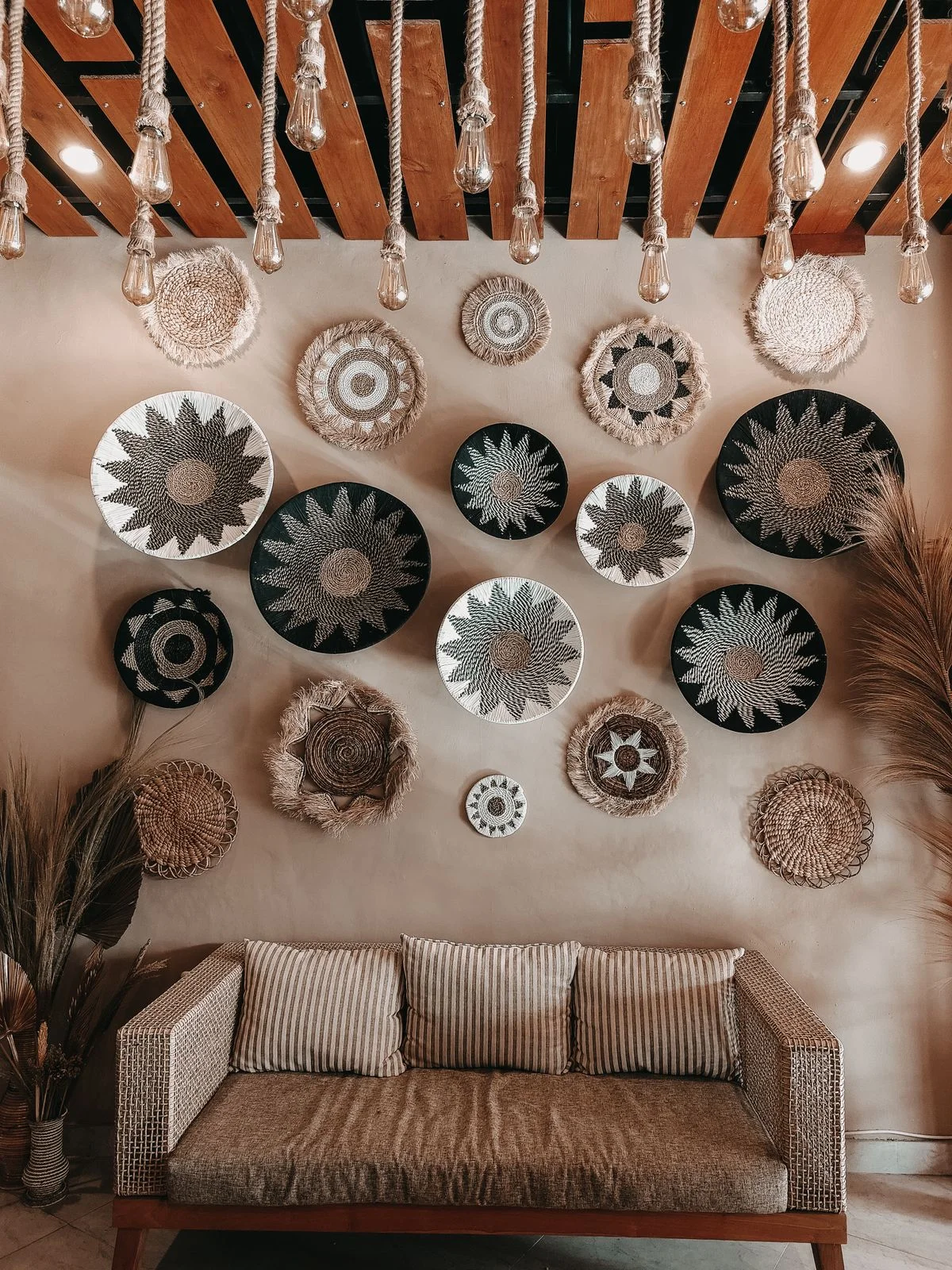 Woven wall baskets displayed on a boho living room wall