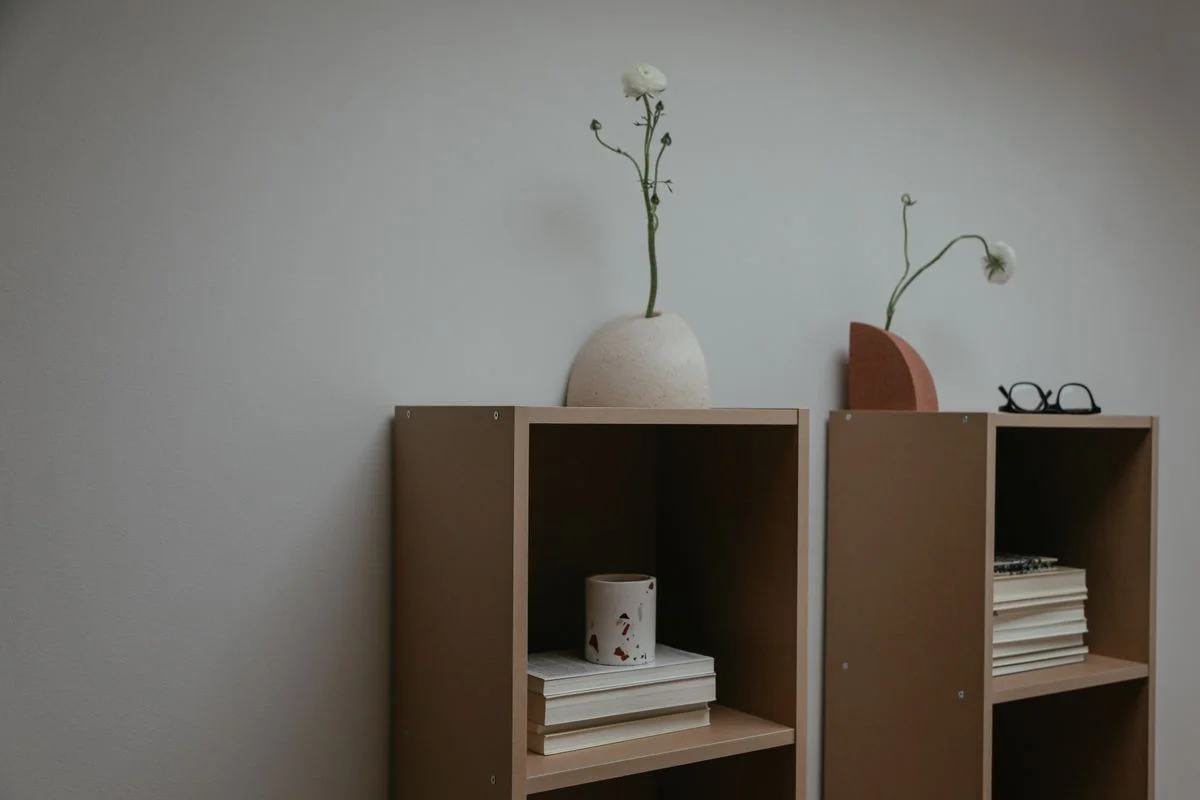Statement vase and trailing plant on top of an office bookshelf