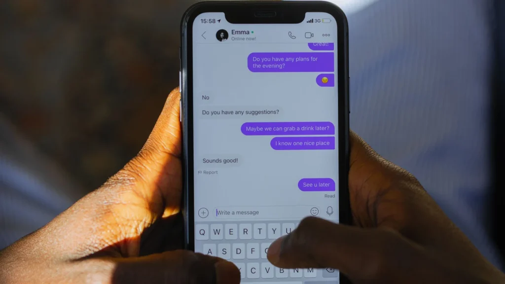 Person texting on a smartphone with chat messages on screen