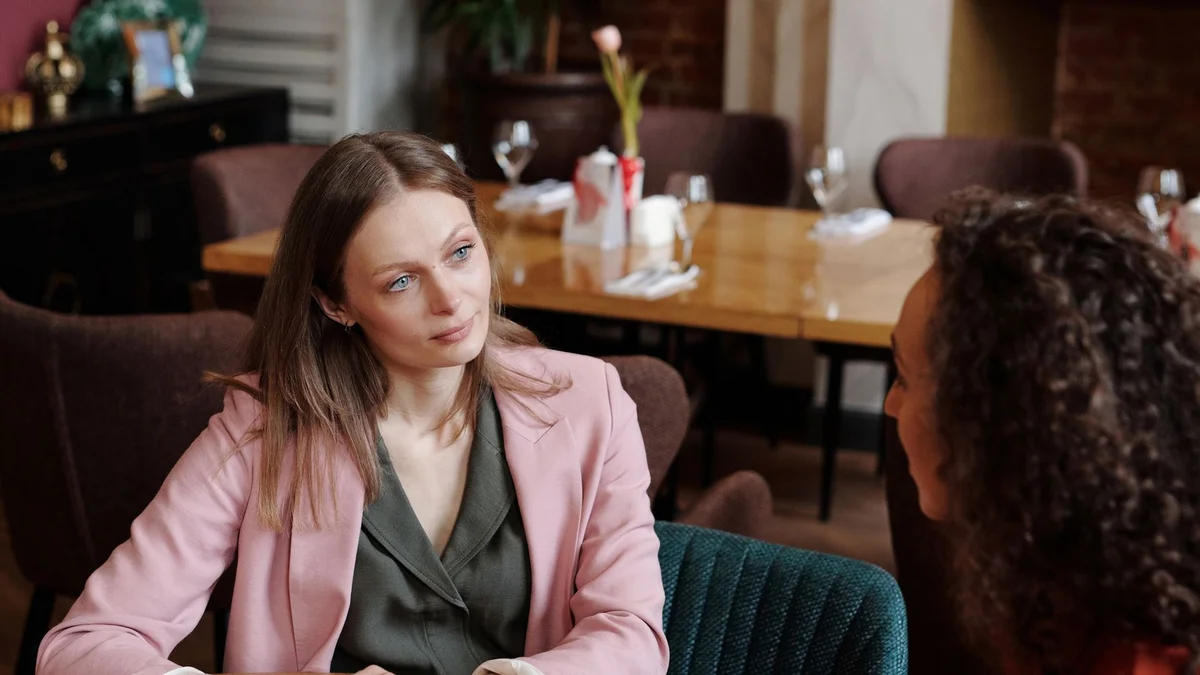 Two people having a thoughtful, engaged conversation over coffee